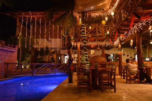a bar with christmas lights and a swimming pool at Hotel Casa San Juan in Valladolid