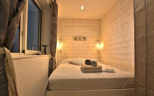 Habitación pequeña con 2 camas y bañera. en TropikAppart, en Les Avirons
