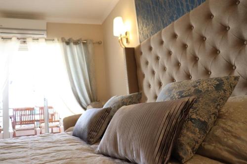 a bedroom with a large bed with pillows on it at Laukamao Praia Da Rocha in Portimão