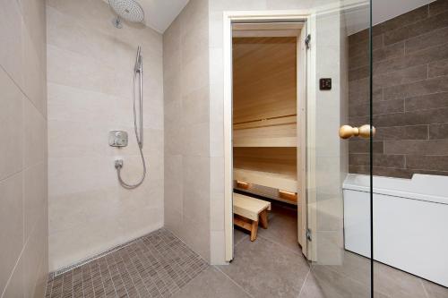 a walk in shower in a bathroom with a tub at Staapli apartment in Tallinn