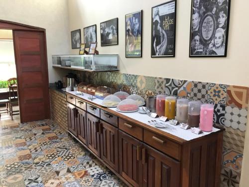 a kitchen with a counter with many items on it at La Dolce Vita Flat & Pousada in Praia do Frances
