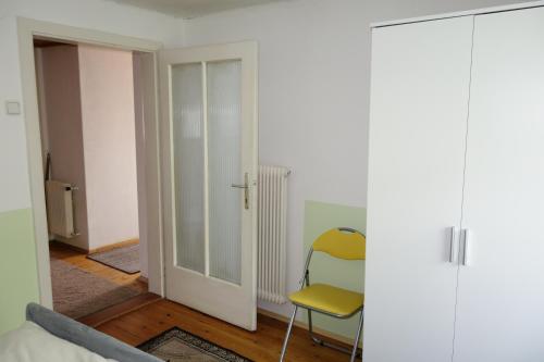 a living room with a door and a chair at Haus Erika in Völkermarkt