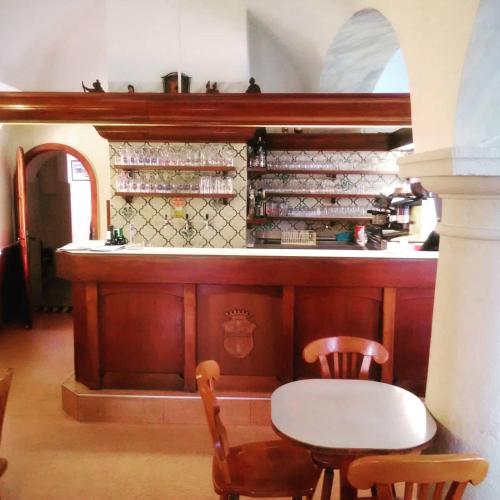 a kitchen with a table and chairs and a counter at Zur goldenen Krone in Ehrenhausen