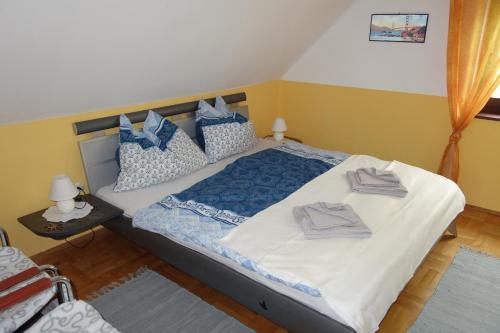 a bedroom with a bed with blue and white pillows at Haus Erika in Völkermarkt