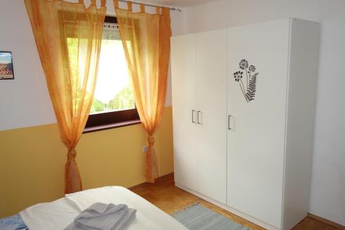 a bedroom with a bed and a window and a door at Haus Erika in Völkermarkt