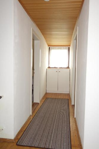 an empty hallway with a door and a rug at Haus Erika in Völkermarkt