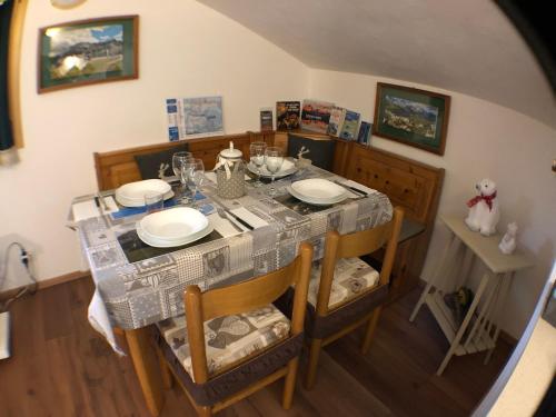 a dining room table and chairs with a table and a table and chairsuggest at Piccolo Nido Falcade in Falcade