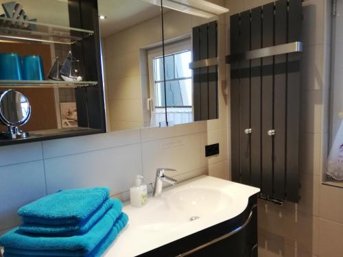 W łazience znajduje się umywalka i lustro. w obiekcie Aquamarina w mieście Bansin