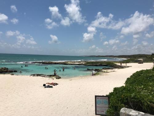 a group of people in the water on a beach at PlayaTurquesa Moderna Casa C/R Auto a 9 min 5ta ave in Playa del Carmen