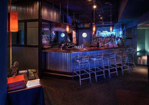 a bar with blue bar stools in a room at Oceanfront Litchfield Inn in Pawleys Island