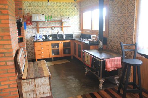 a kitchen with an old fashioned stove in it at Casa da Montanha in Urubici