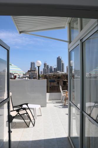 a balcony with a chair and a view of a city at Beutifull view of batyam in Bat Yam