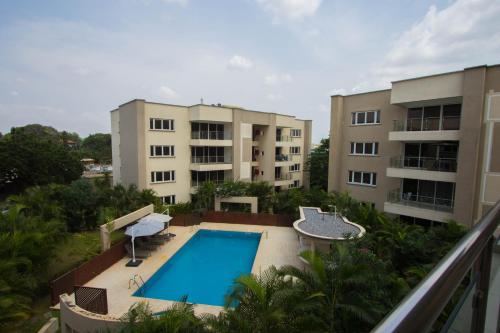 an apartment with a swimming pool and two buildings at 90 Independence Avenue in Accra