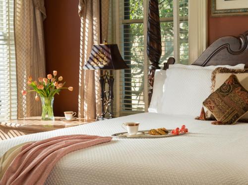 a bed with a plate of food on top of it at The Inn on West Liberty in Savannah