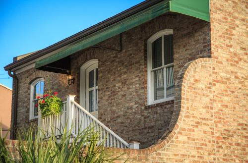 a brick house with a staircase and a window at The Inn on West Liberty in Savannah