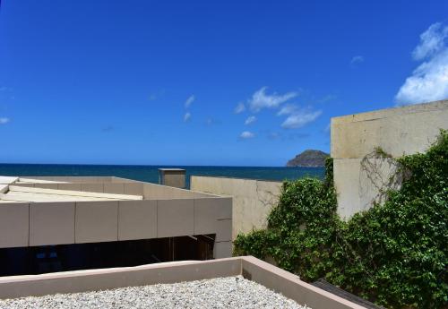 a concrete building with the ocean in the background at Ariadne Beach in Plataniás