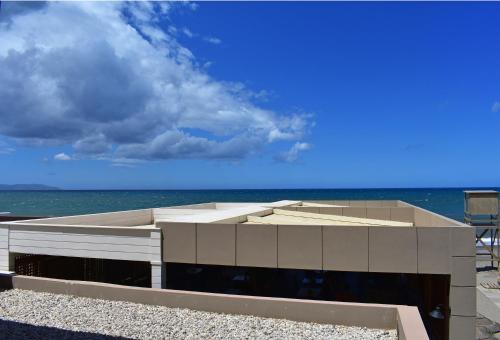 a building on the beach with the ocean in the background at Ariadne Beach in Plataniás