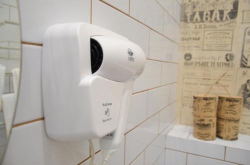 a white hairdryer on a wall in a bathroom at Apartment nr. 8 in Odesa