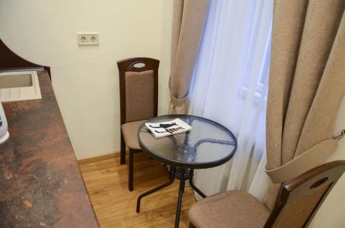 a small table and chairs in a room with a window at Apartment nr. 8 in Odesa