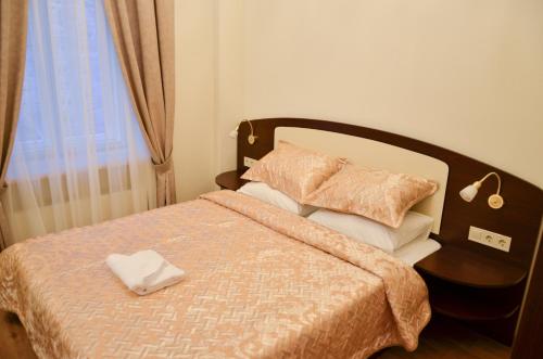 a bedroom with a bed with a pillow and a window at Apartment nr. 8 in Odesa