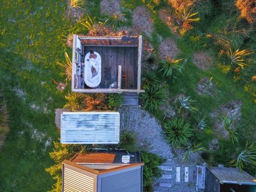 an overhead view of a building with a cat in a window at Appleby House & Rabbit Island Huts in Mapua