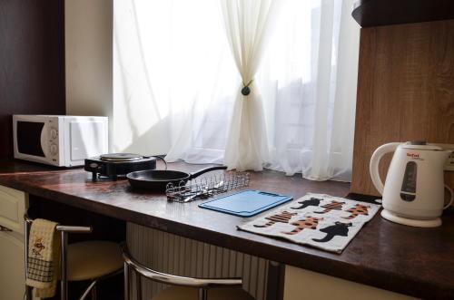 a kitchen with a counter top with a microwave and a table at Apartment nr. 8 in Odesa