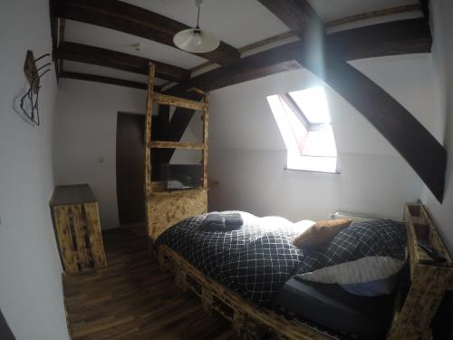 a bedroom with a bed and a wooden ladder at Haus Feierabend in Plodda