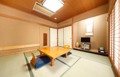 a living room with a table and chairs at Wakamatsu Honten in Narita