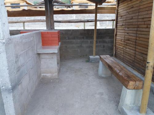 an outdoor area with a bench and an umbrella at Cabañas Rivadavia Spa in Vicuña