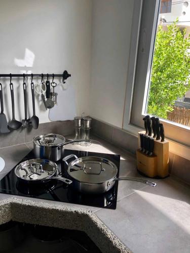 a kitchen with two pots and pans on a stove at Sandy Feet House in Puerto Villamil