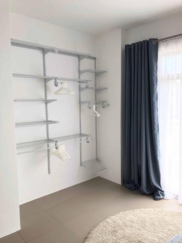 a room with shelves on the wall with a window at Flip Flop House in Puerto Villamil