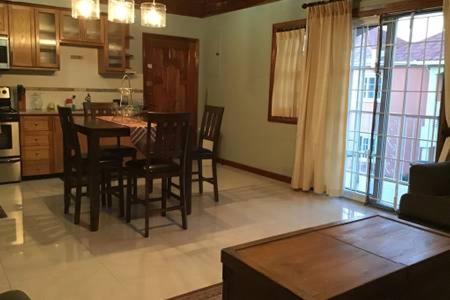 a kitchen and dining room with a table and chairs at 12 Fairway Avenue in Kingston