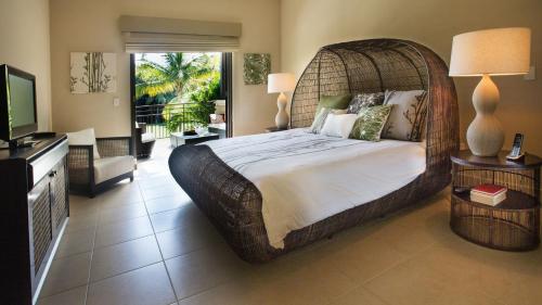 a large bedroom with a large bed and a television at Villa Esmeralda in Rio Grande
