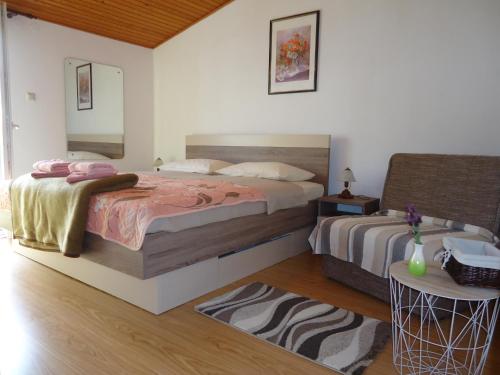 A bed or beds in a room at Apartments Matuč