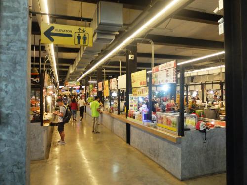 a grocery store with people walking through the aisle at HDY 16 Home in Hat Yai