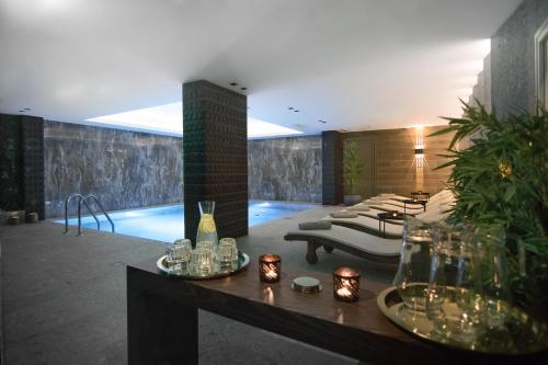 a living room with a pool in a building at Ntinas Filoxenia Hotel & Spa in Skala Potamias