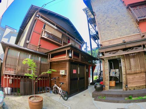 a house with a bike parked in front of it at Benidaruma - Dango in Kyoto