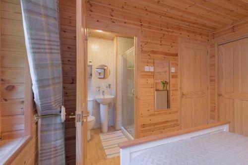 a bathroom with a shower and a toilet in a room at Ben Macdui in Banchory
