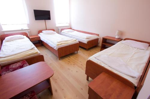 a room with three bunk beds and a television at Wisełka PERŁA Bałtyku in Wisełka