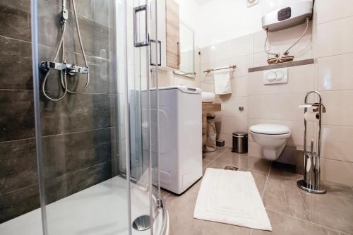 a bathroom with a shower and a toilet at Heart of Town in Zadar