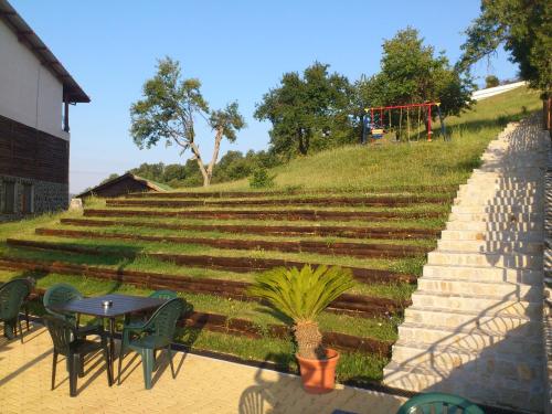 a set of stairs with a table and chairs at Panorama Family Hotel in Zlatograd
