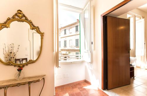 a hallway with a mirror and a door at Centro Storico Carlo Alberto in Alghero