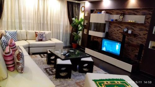 a living room with a couch and a tv at Hamdy 5 Star (Families Only) in Cairo