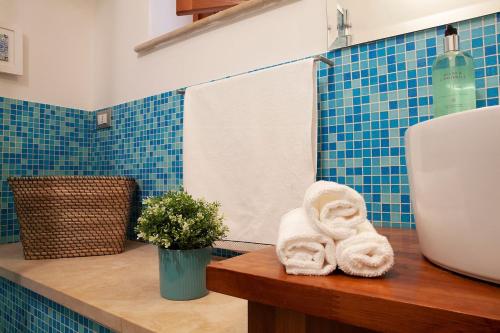 a bathroom with a sink and a towel on a counter at 44 Steps - Enjoy Noto in Noto