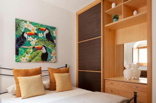 a bedroom with a bed and a large painting on the wall at 44 Steps - Enjoy Noto in Noto