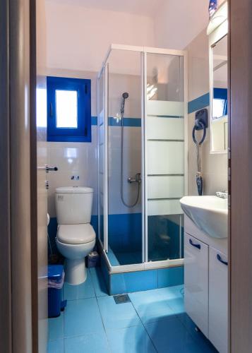 a bathroom with a shower and a toilet and a sink at Navy Greece Villa with swimming pool & sea view in Makrygialos