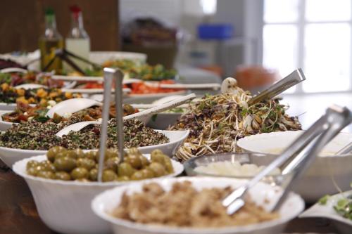 a buffet with many plates of food on a table at Kibbutz Beit Alfa Guest House in Bet Alfa