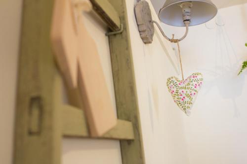 a heart hanging on a door with a light at Wisełka PERŁA Bałtyku in Wisełka