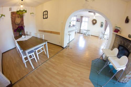 a living room with a table and a dining room at Wisełka PERŁA Bałtyku in Wisełka