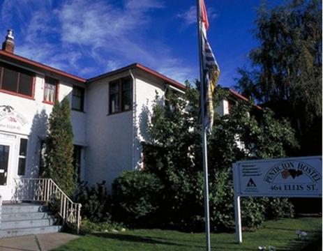 a flag in front of a house with a sign at HI Penticton - Hostel in Penticton